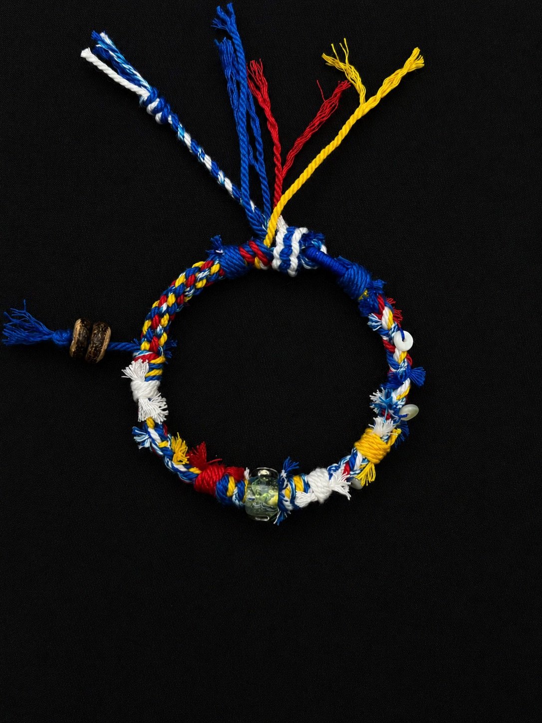 Blue, white, red and yellow handmade cord bracelet