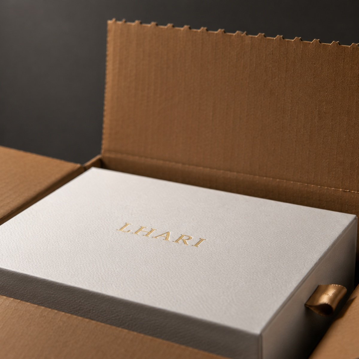 LHARI white presentation box inside its protective outer packaging