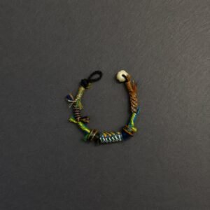 LHARI Kora Wind Protection Bracelet black background overhead view