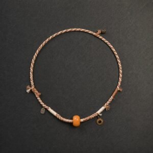 LHARI Silent Sun Necklace black background overhead view