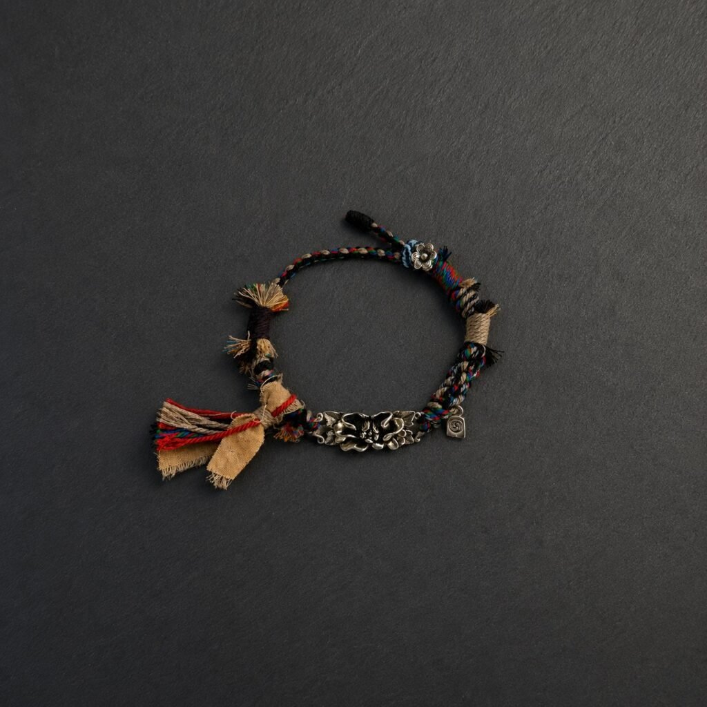 LHARI Silver Lotus Protection Bracelet black background overhead view