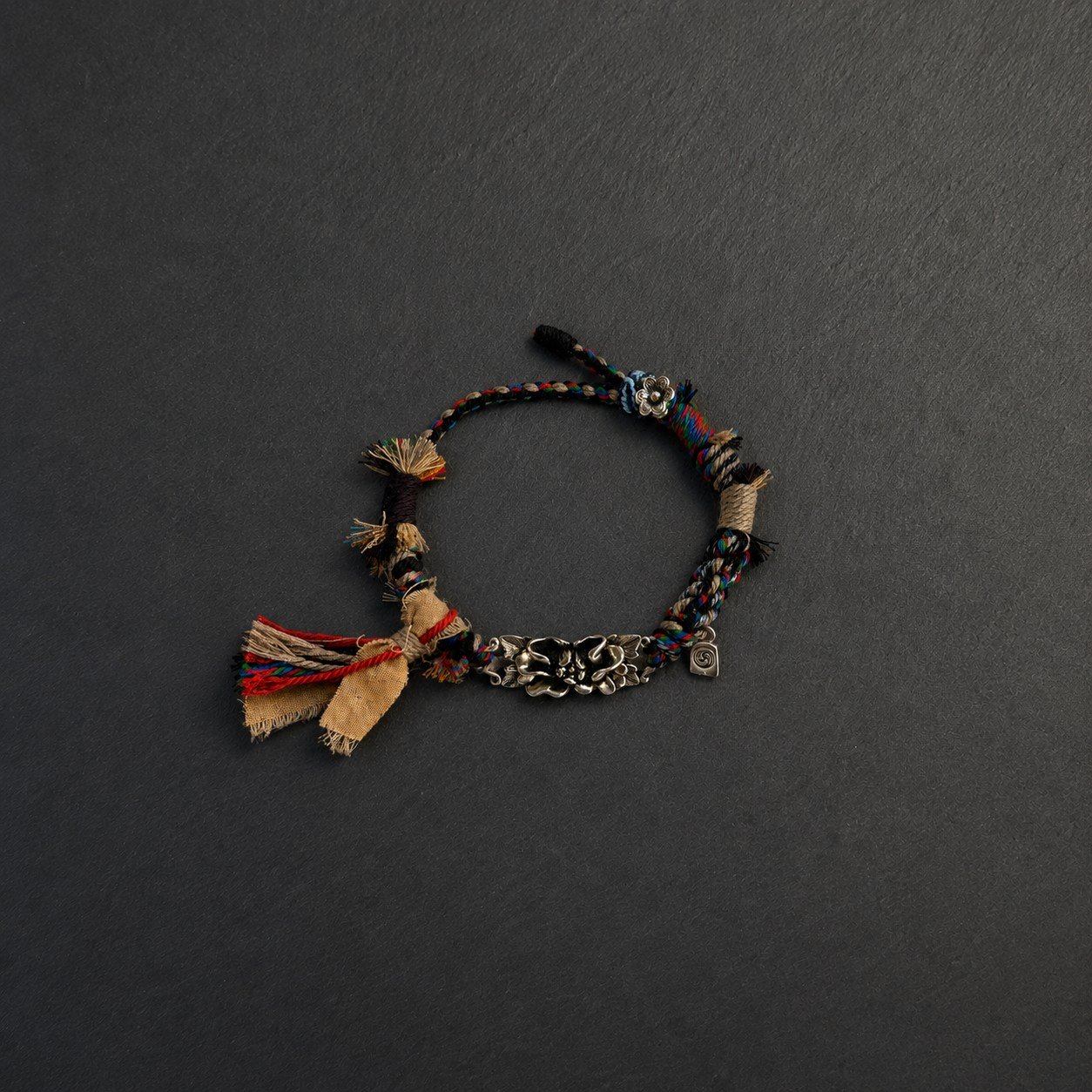 LHARI Silver Lotus Protection Bracelet black background overhead view