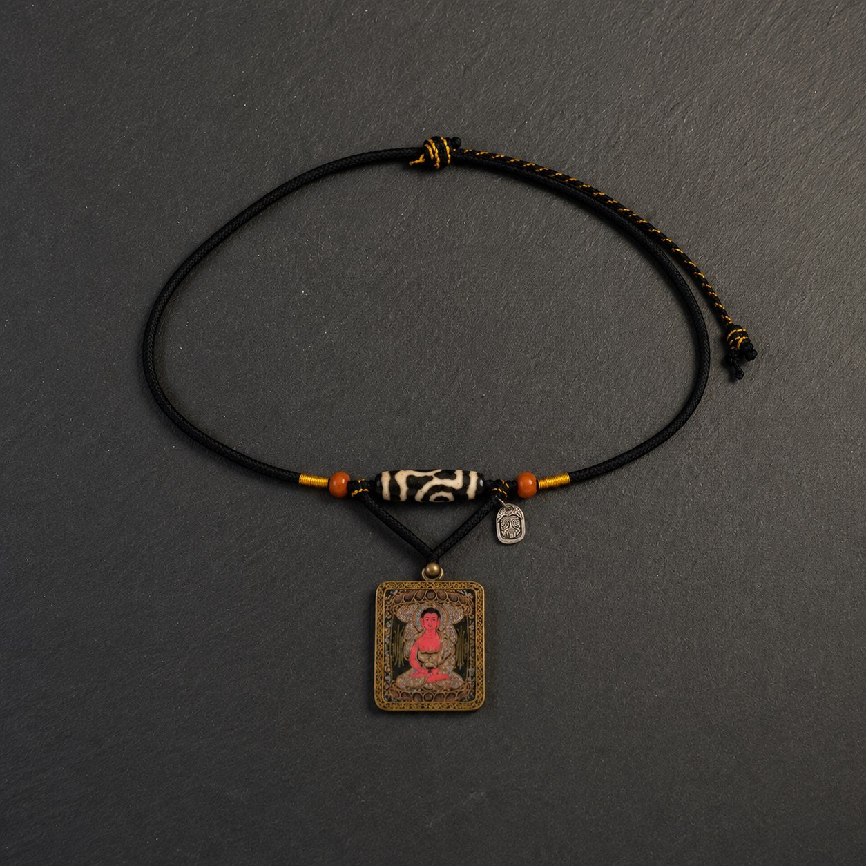 LHARI The Dzi Reliquary black background overhead view