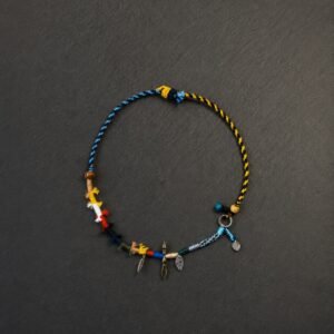 LHARI Wind Prayer Cord Necklace black background overhead view